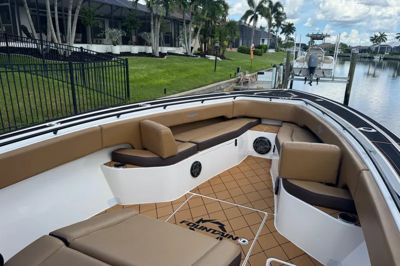  Yacht Photos Pics 2020 Fountain 38 Center Console boat with tan seating, docked by a canal.