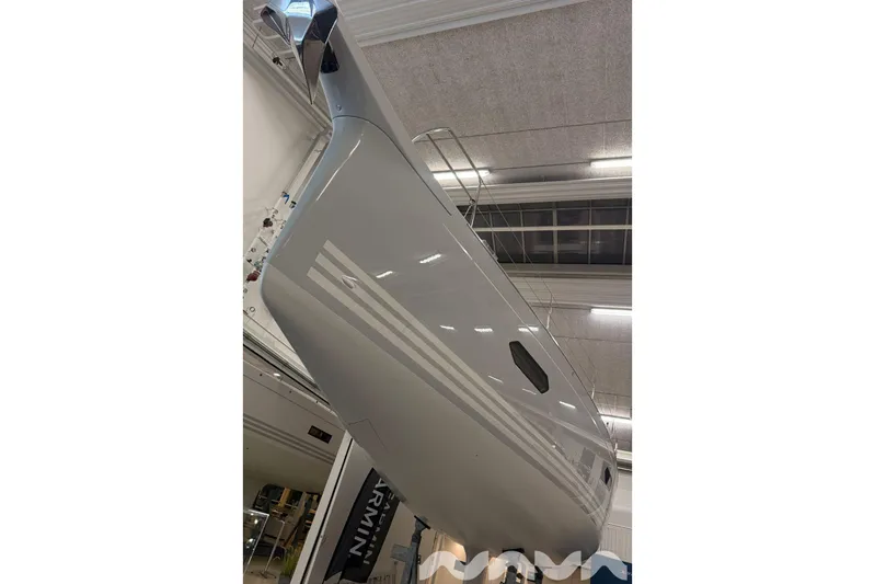  Yacht Photos Pics 2024 X-Yachts Xc 47 sailboat hull in a showroom, showcasing sleek design.