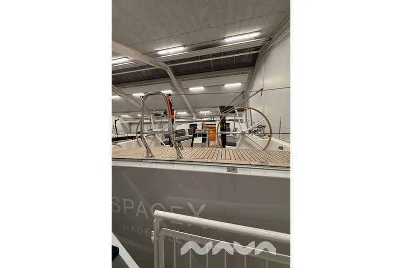  Yacht Photos Pics 2024 X-Yachts Xc 47 sailboat interior with wooden deck and steering wheel.