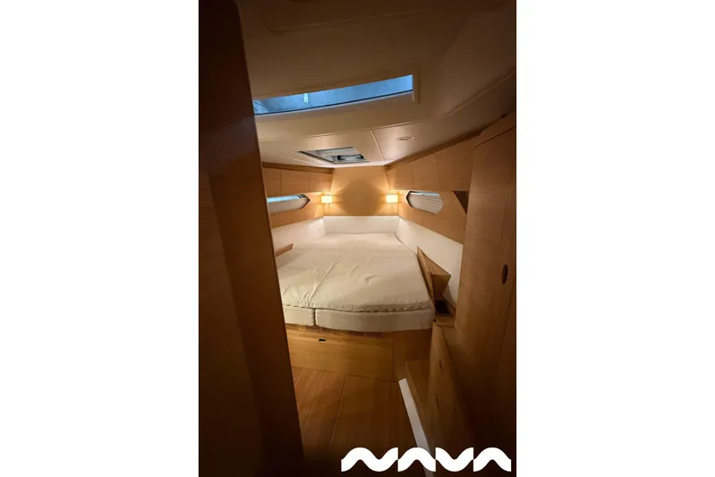  Yacht Photos Pics Luxurious cabin interior of 2024 X-Yachts Xc 47 with wooden finish and cozy lighting.