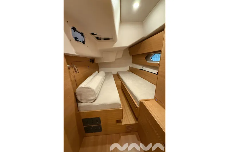  Yacht Photos Pics 2024 X-Yachts Xc 47 interior cabin with wooden finish and cozy bedding.