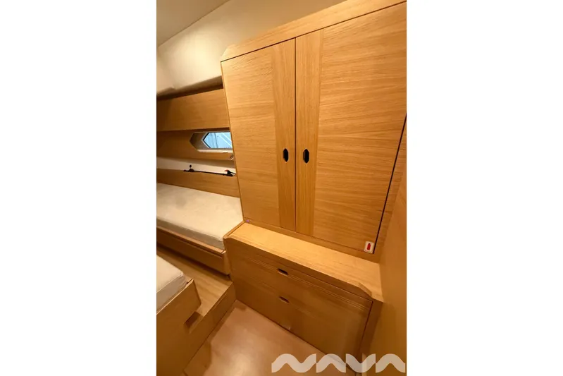  Yacht Photos Pics 2024 X-Yachts Xc 47 cabin interior with wooden cabinetry and bed.