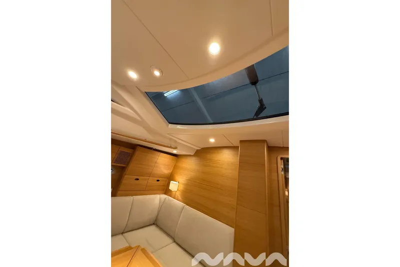  Yacht Photos Pics Interior of 2024 X-Yachts Xc 47, featuring skylight and modern wood paneling.