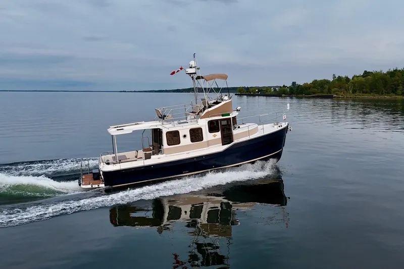  Yacht Photos Pics 2025 Ranger Tugs R-31 CB cruising on calm waters, showcasing sleek design and performance.