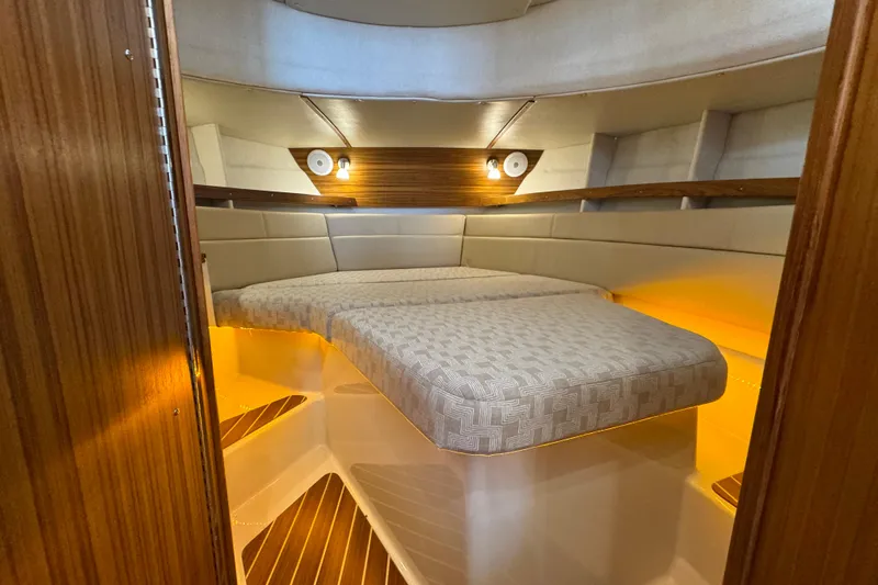  Yacht Photos Pics 2025 Ranger Tugs R-31 CB cabin interior with cozy lighting and elegant wood finish.