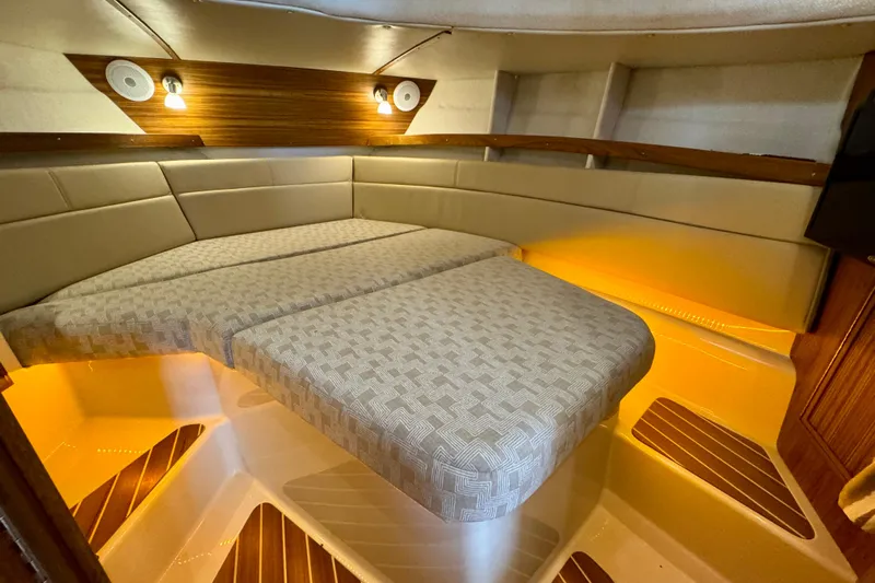  Yacht Photos Pics Interior of 2025 Ranger Tugs R-31 CB boat with cozy sleeping area and ambient lighting.