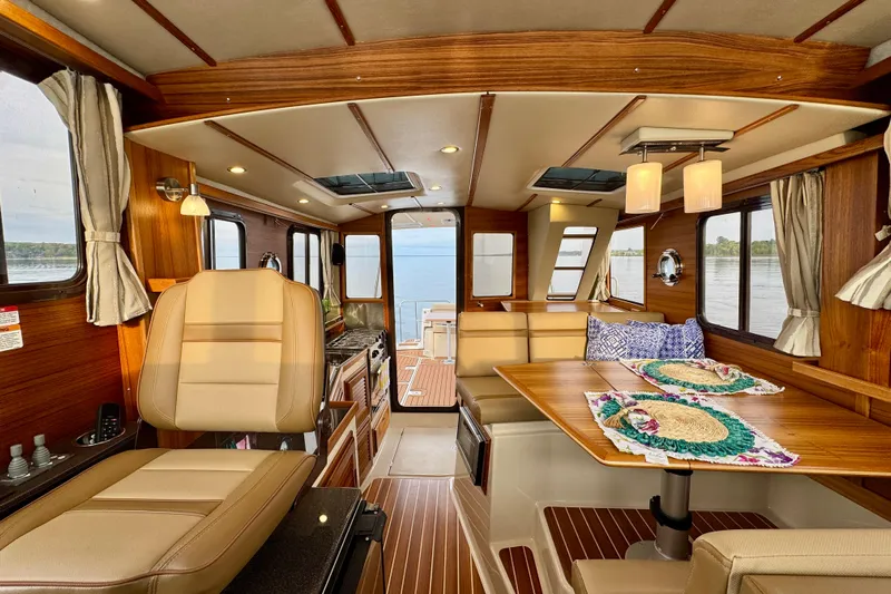  Yacht Photos Pics Luxurious interior of 2025 Ranger Tugs R-31 CB with elegant wood finish and seating.