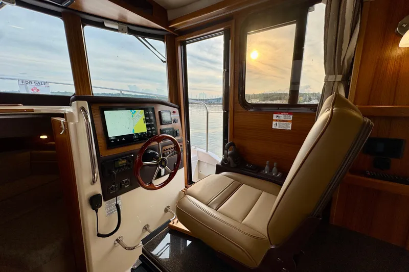  Yacht Photos Pics Interior of 2025 Ranger Tugs R-31 CB with helm, navigation screen, and leather seat.