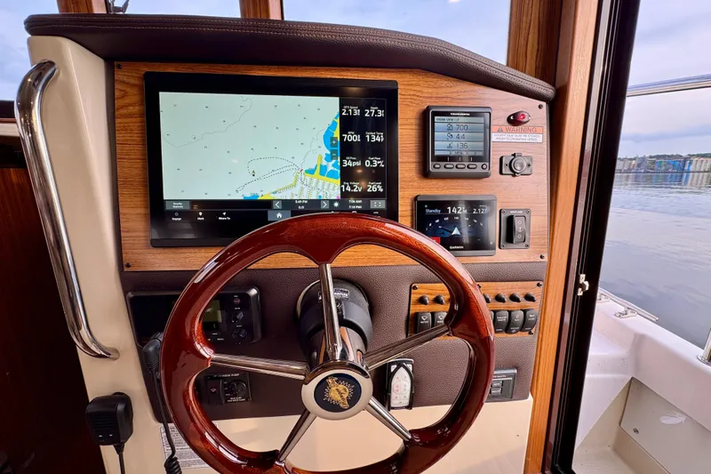  Yacht Photos Pics Steering console of 2025 Ranger Tugs R-31 CB with navigation display and controls.