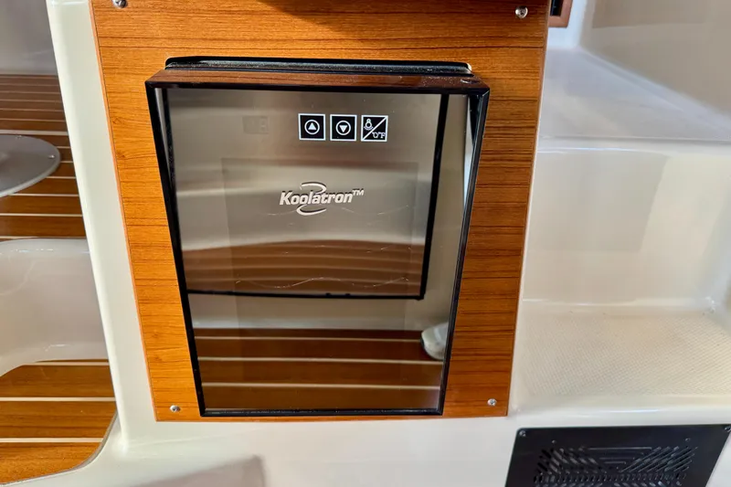  Yacht Photos Pics Koolatron fridge in 2025 Ranger Tugs R-31 CB boat interior, featuring wood paneling.