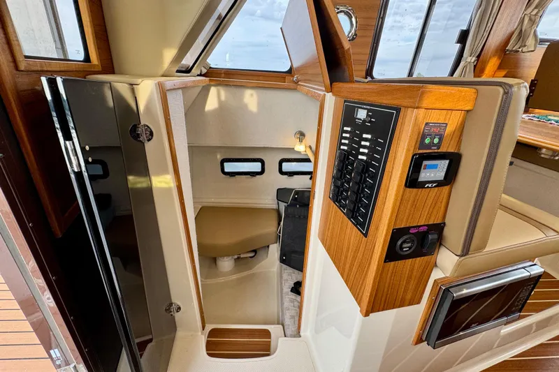  Yacht Photos Pics 2025 Ranger Tugs R-31 CB interior with control panel and cabin view.