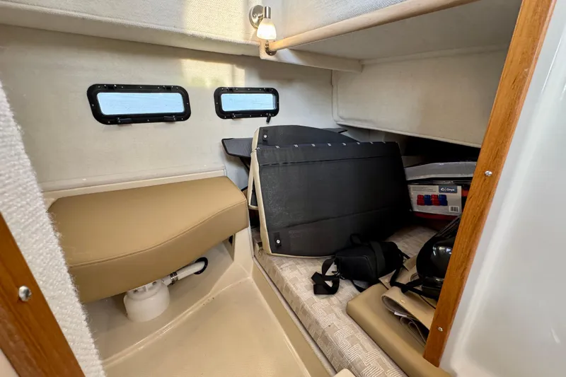  Yacht Photos Pics 2025 Ranger Tugs R-31 CB cabin interior with seating and storage space.