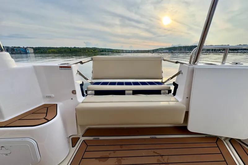  Yacht Photos Pics 2025 Ranger Tugs R-31 CB boat with seating, scenic sunset view on calm water.