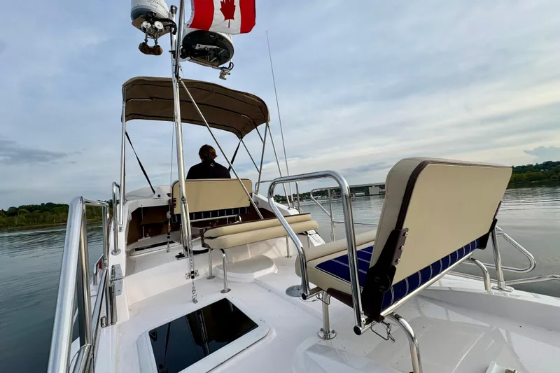  Yacht Photos Pics 2025 Ranger Tugs R-31 CB boat with Canadian flag on calm water.