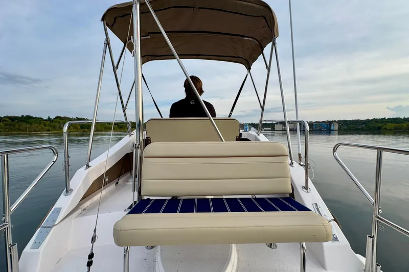 Yacht Photos Pics 2025 Ranger Tugs R-31 CB boat with canopy, cruising on calm waters.