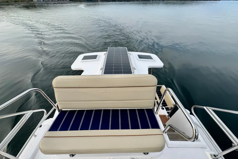  Yacht Photos Pics 2025 Ranger Tugs R-31 CB boat with solar panels on calm water.