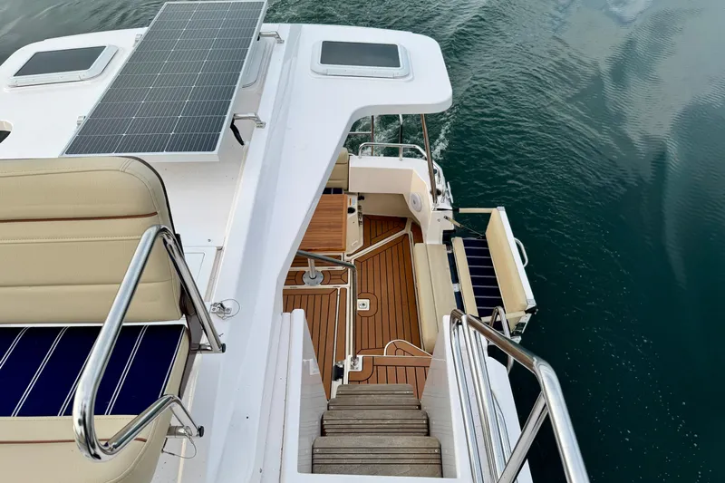  Yacht Photos Pics 2025 Ranger Tugs R-31 CB boat deck with solar panel and seating, overlooking water.