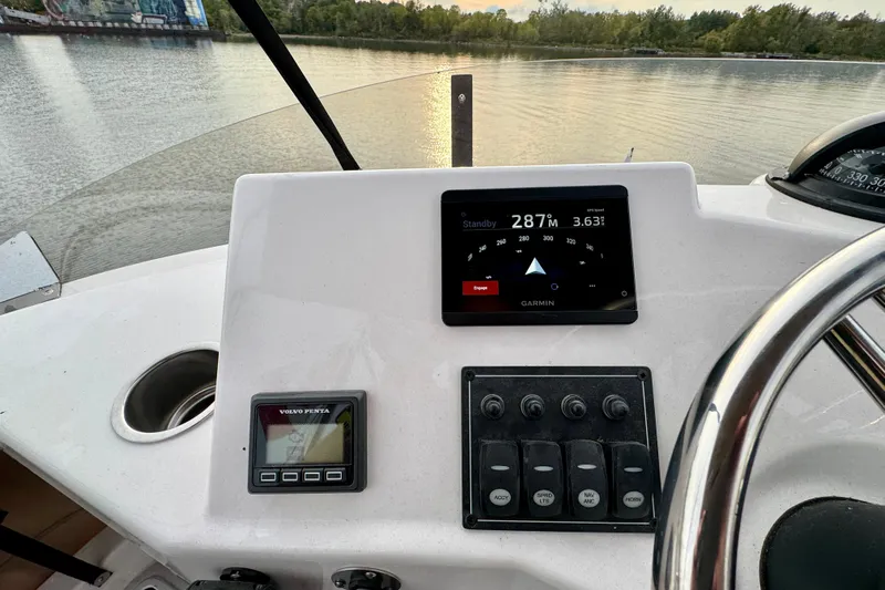  Yacht Photos Pics Helm of 2025 Ranger Tugs R-31 CB with Garmin navigation display on calm water.