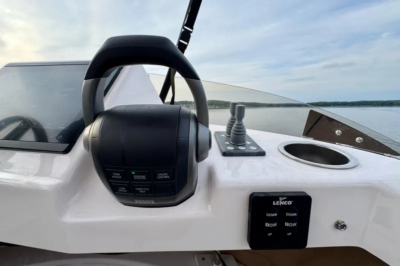  Yacht Photos Pics 2025 Ranger Tugs R-31 CB helm with controls and display, overlooking serene water.
