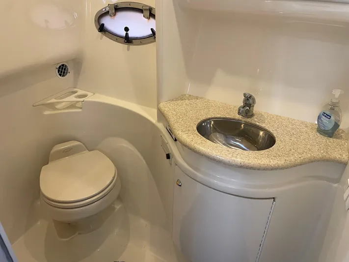  Yacht Photos Pics 2003 Formula 37 PC yacht bathroom with toilet, sink, and porthole window.