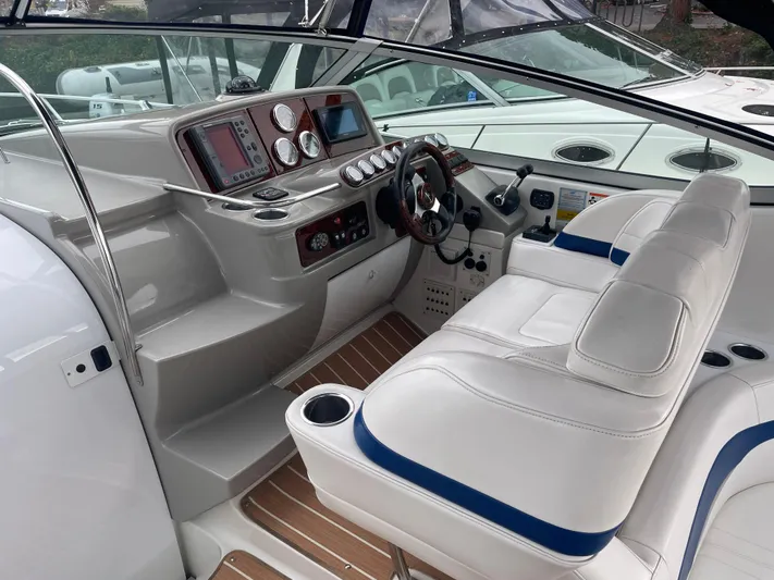  Yacht Photos Pics 2003 Formula 37 PC yacht cockpit with white seating and modern control panel.