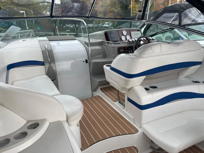  Yacht Photos Pics 2003 Formula 37 PC boat interior with white seating and wood flooring.