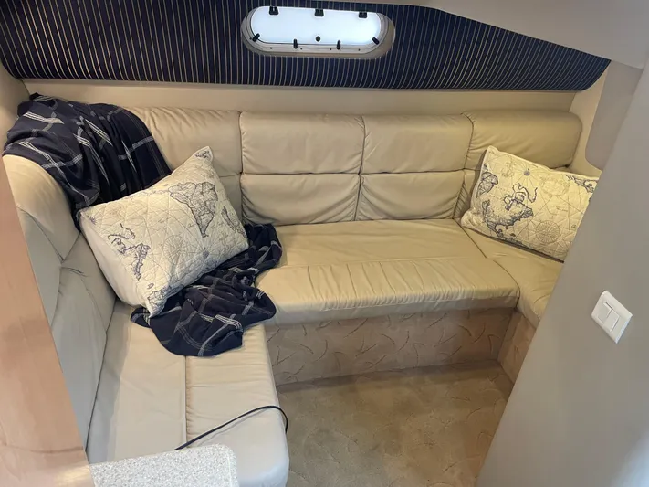  Yacht Photos Pics Luxurious beige leather seating in 2003 Formula 37 PC cabin with nautical-themed pillows.