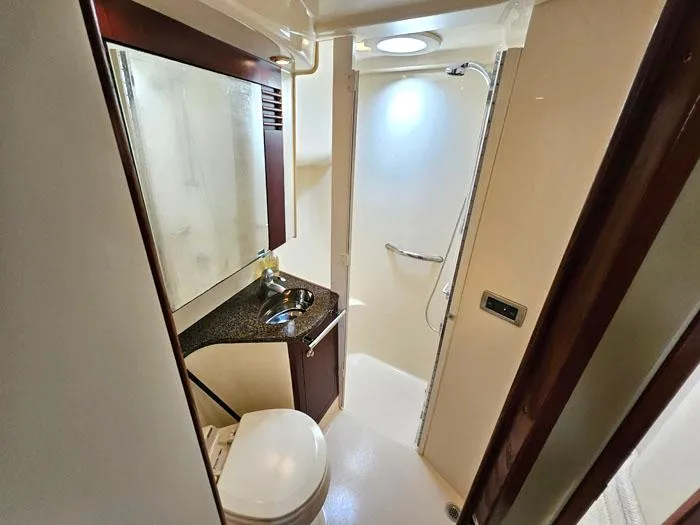  Yacht Photos Pics Bathroom interior of 2006 Sea Ray 44 Sedan Bridge yacht, featuring shower and vanity.
