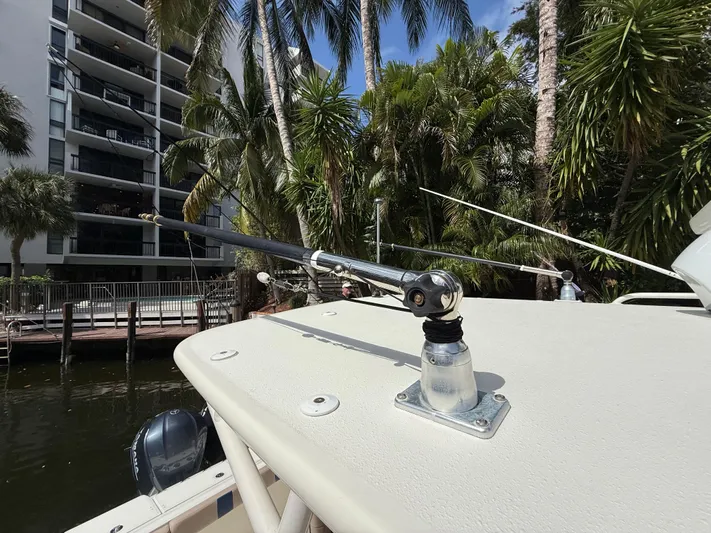  Yacht Photos Pics 2008 Hydra-Sports Vector 3500 VX boat with fishing rod holder, surrounded by tropical trees.