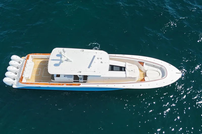  Yacht Photos Pics Aerial view of 2021 HCB 65 Estrella yacht cruising on blue ocean waters.