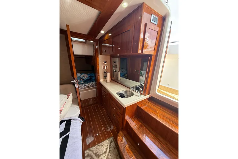  Yacht Photos Pics Luxurious interior of 2021 HCB 65 yacht with polished wood and modern amenities.