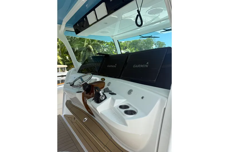  Yacht Photos Pics Helm of 2021 HCB 65 boat with Garmin navigation displays and steering wheel.
