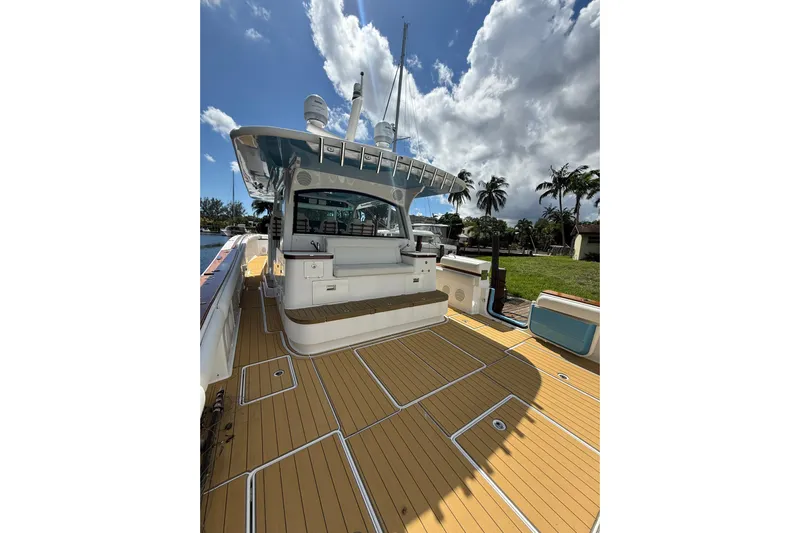  Yacht Photos Pics 2021 HCB 65 yacht deck with sleek design, under a partly cloudy sky.