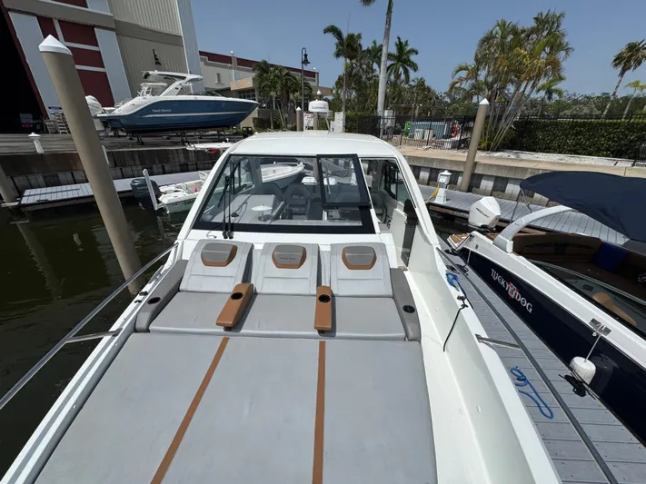 Eleven Eleven Yacht Photos Pics 2022 Beneteau Gran Turismo 32 yacht docked, featuring spacious sunbathing area and sleek design.