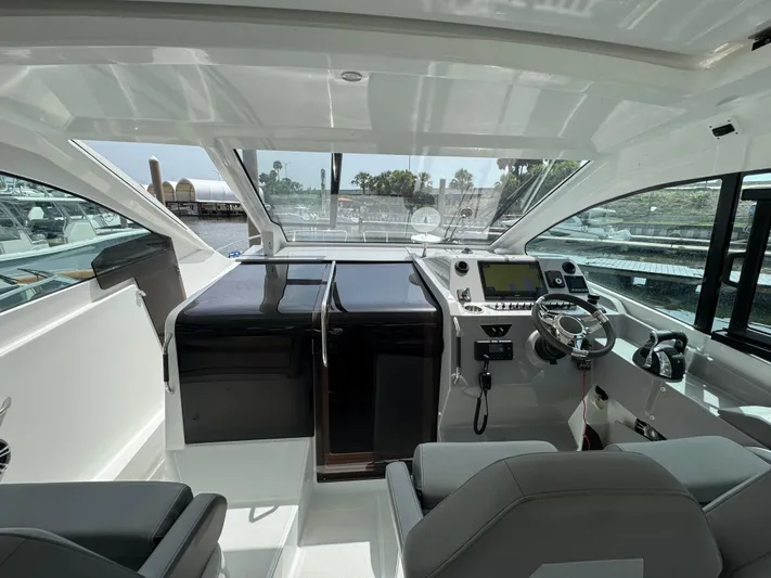 Eleven Eleven Yacht Photos Pics 2022 Beneteau Gran Turismo 32 cockpit with modern controls and panoramic windows.