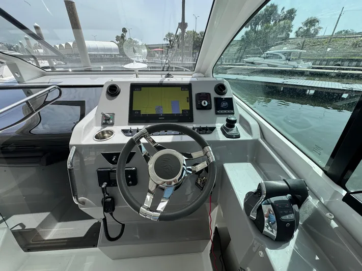 Eleven Eleven Yacht Photos Pics Cockpit of 2022 Beneteau Gran Turismo 32 with steering wheel and navigation display.