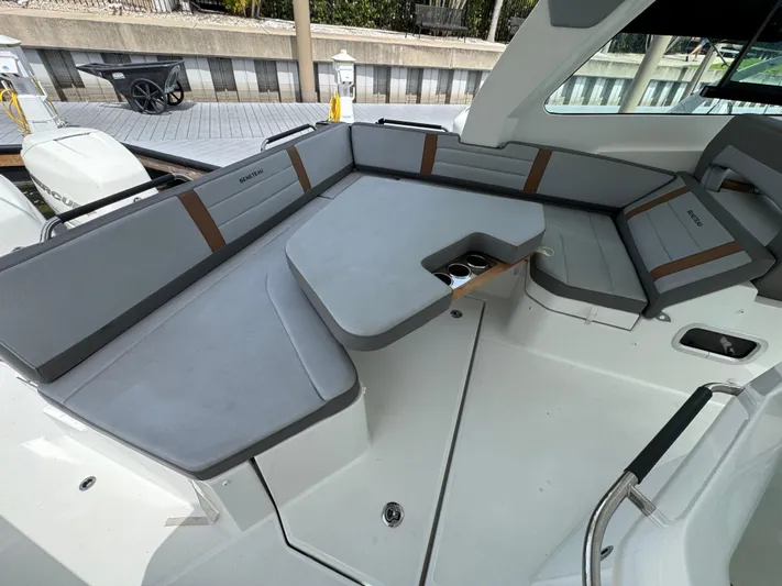 Eleven Eleven Yacht Photos Pics 2022 Beneteau Gran Turismo 32 interior with sleek gray seating and modern design.