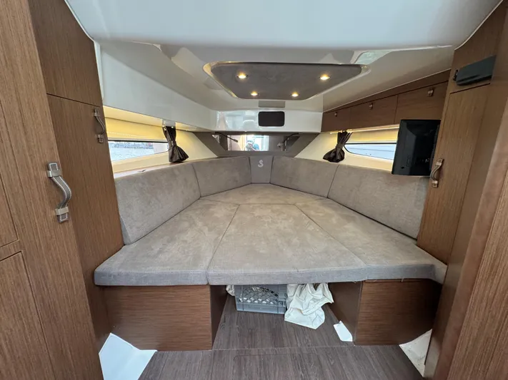 Eleven Eleven Yacht Photos Pics Interior cabin of 2022 Beneteau Gran Turismo 32 yacht, featuring cozy seating and modern design.