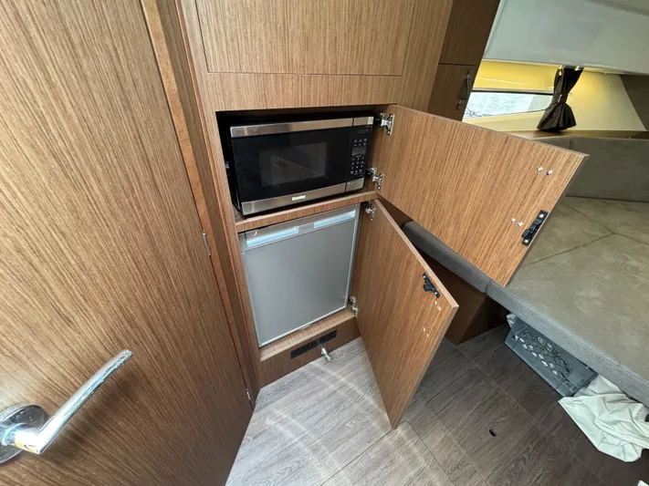 Eleven Eleven Yacht Photos Pics 2022 Beneteau Gran Turismo 32 interior kitchen with microwave and fridge.