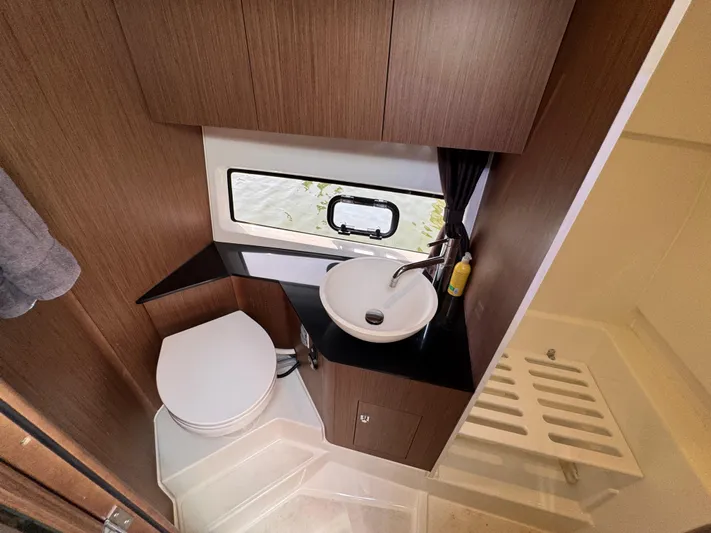 Eleven Eleven Yacht Photos Pics 2022 Beneteau Gran Turismo 32 bathroom with sink, toilet, and window.