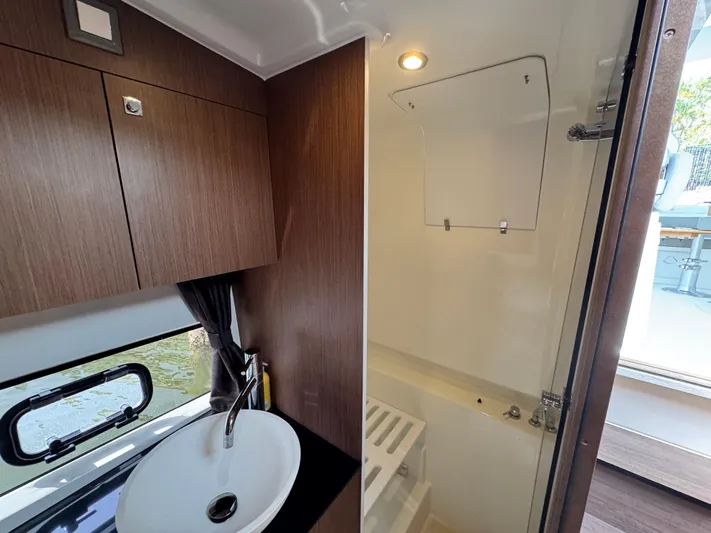 Eleven Eleven Yacht Photos Pics Interior of 2022 Beneteau Gran Turismo 32 yacht bathroom with sink and shower.