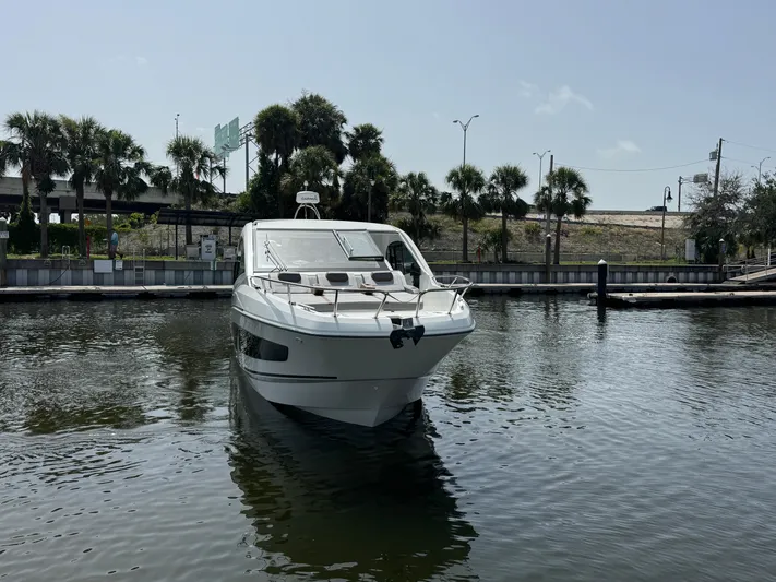 Eleven Eleven Yacht Photos Pics 2022 Beneteau Gran Turismo 32 yacht docked in a marina with palm trees.