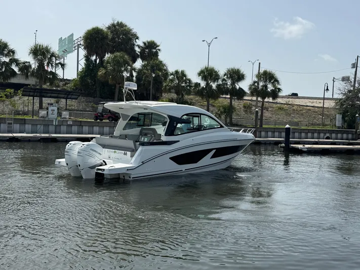 Eleven Eleven Yacht Photos Pics 2022 Beneteau Gran Turismo 32 yacht on calm water near a marina.