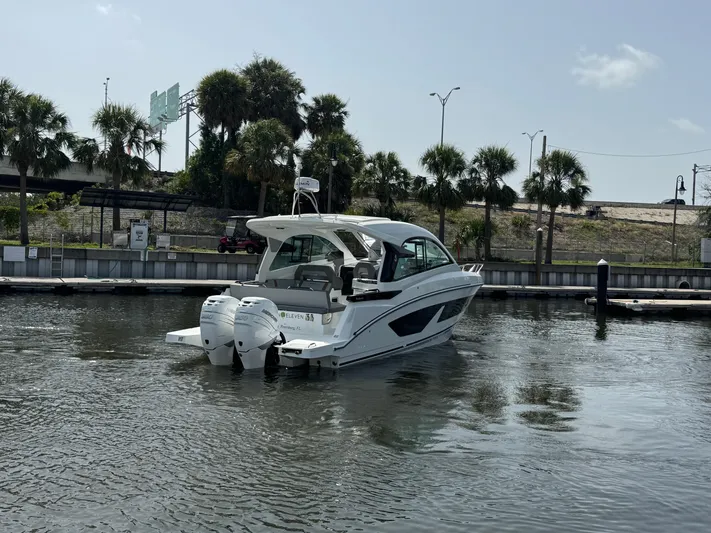 Eleven Eleven Yacht Photos Pics 2022 Beneteau Gran Turismo 32 yacht on calm water with palm trees in background.