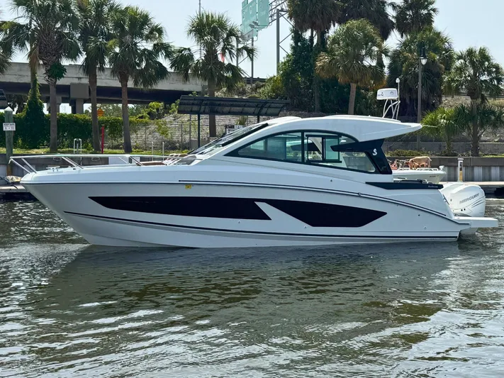Eleven Eleven Yacht Photos Pics 2022 Beneteau Gran Turismo 32 yacht docked near palm trees.