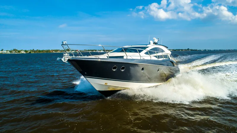  Yacht Photos Pics 2009 Marquis 500 Sport Coupe yacht cruising on open water.