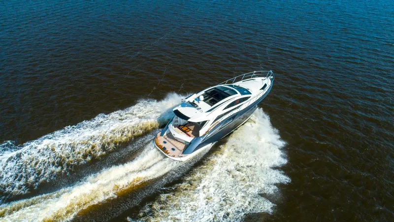  Yacht Photos Pics Aerial view of a 2009 Marquis 500 Sport Coupe yacht cruising on open water.