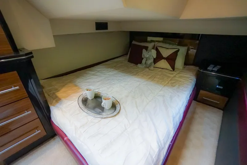  Yacht Photos Pics Luxurious bedroom in 2009 Marquis 500 Sport Coupe yacht with cozy bedding and coffee tray.