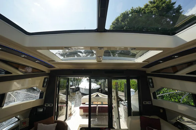  Yacht Photos Pics Interior view of 2009 Marquis 500 Sport Coupe yacht with sunroof and outdoor seating area.