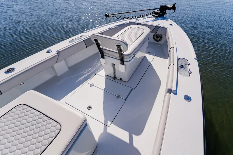  Yacht Photos Pics 2024 Dorado 25 boat interior with seating and storage, on calm water.